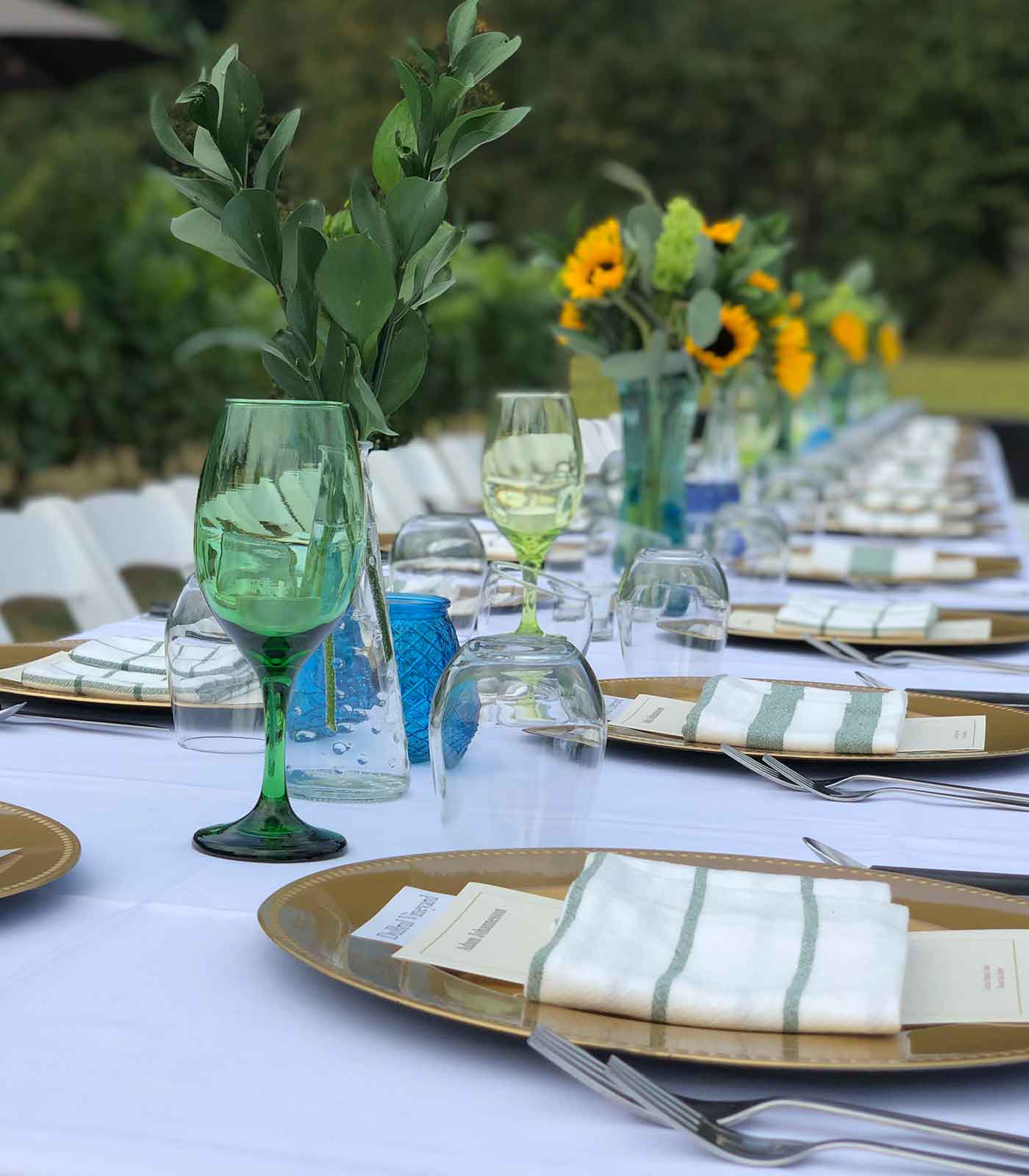 Photo of Dinner Table with a White Table Cloth and all the Cutleries Neatly Arranged to host an Event at Pomeroy Cellars